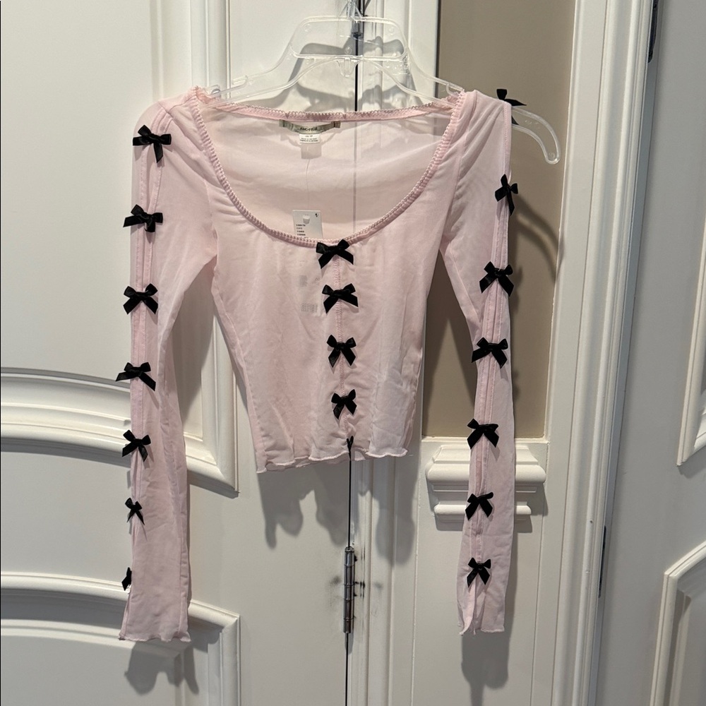 Urban Outfitters Pale Pink Long Sleeve Crop Top with Black Bows